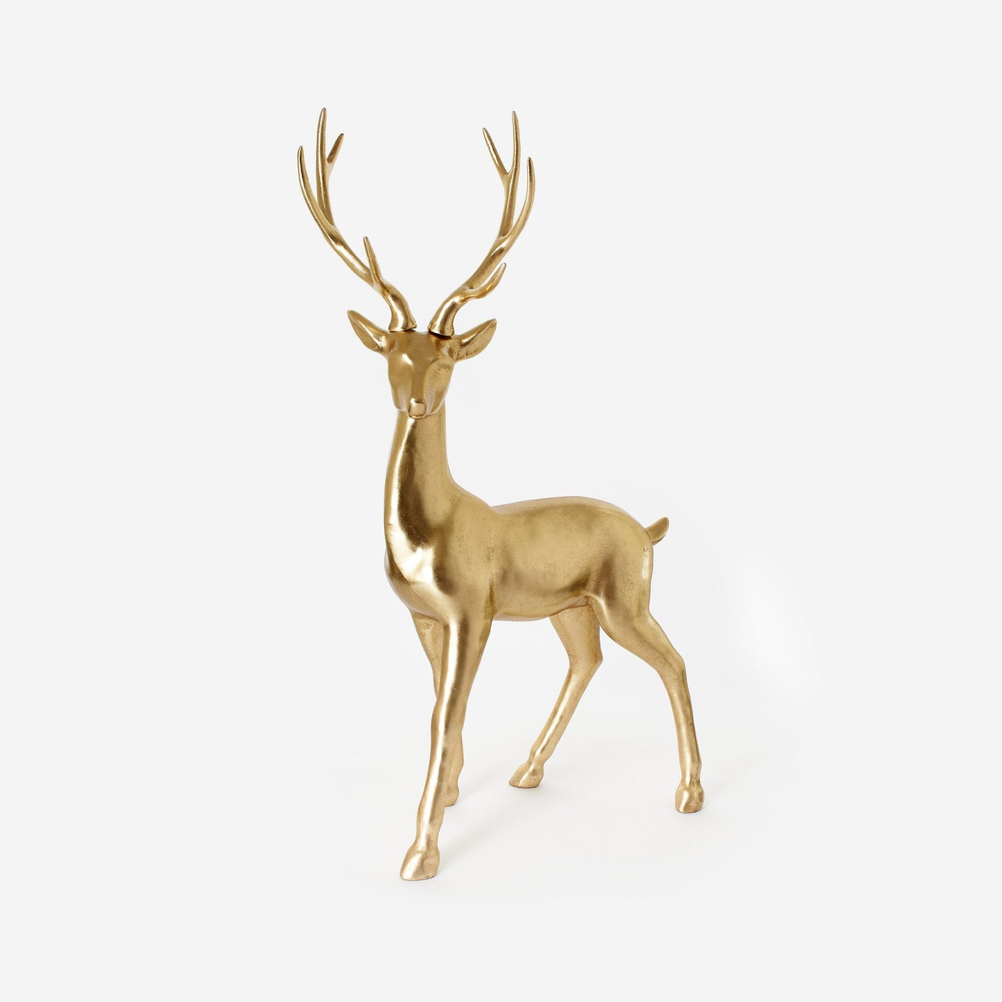 Gold deer figurine on a light gray background