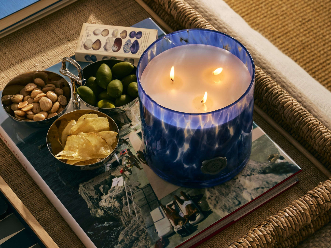 Blue luxury jar scented candles from the Candles collection with snacks on a stylish coffee table.