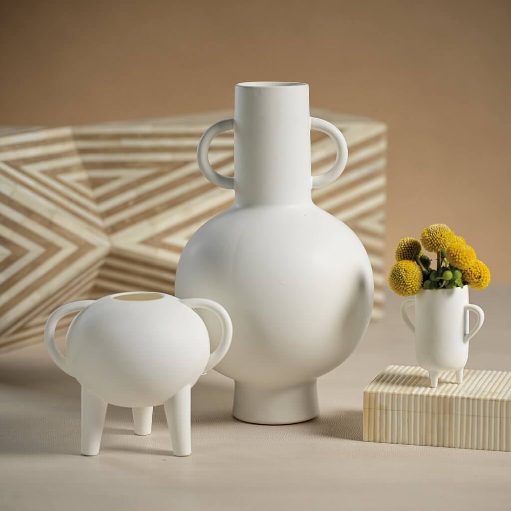 White handcrafted ceramics vases and planters showcasing modern design and artistry for any space.