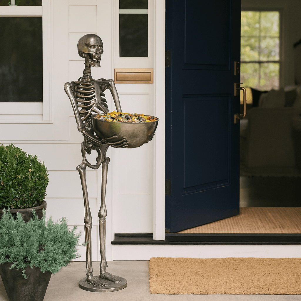 Halloween skeleton holding a bowl filled with candy at a home entryway, enhancing festive charm for the season.