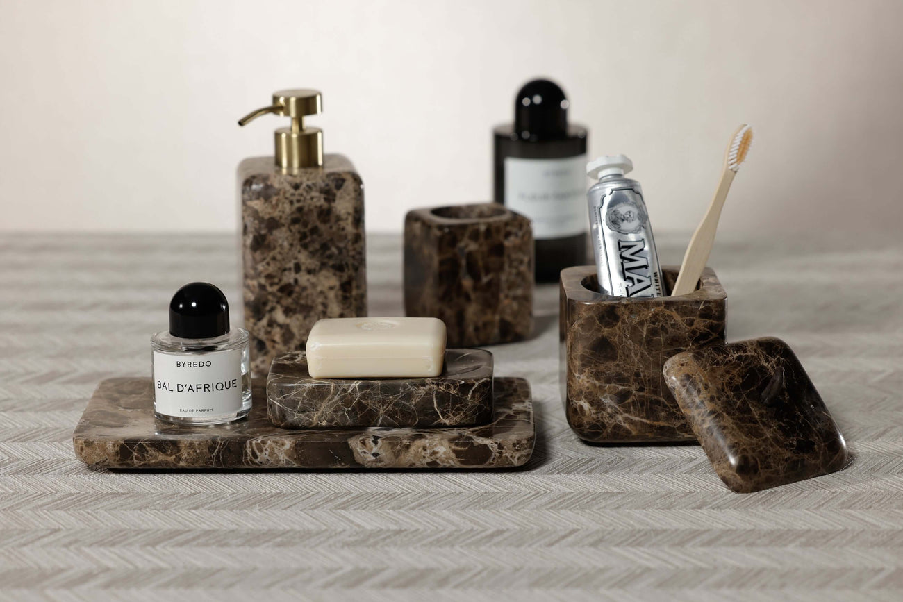 Elegant home organization accessories including marble trays and holders for a stylish bathroom decor.