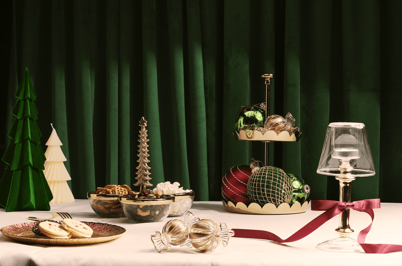 Elegant table setting featuring ornaments and treats from the Holiday 2025 Collection.