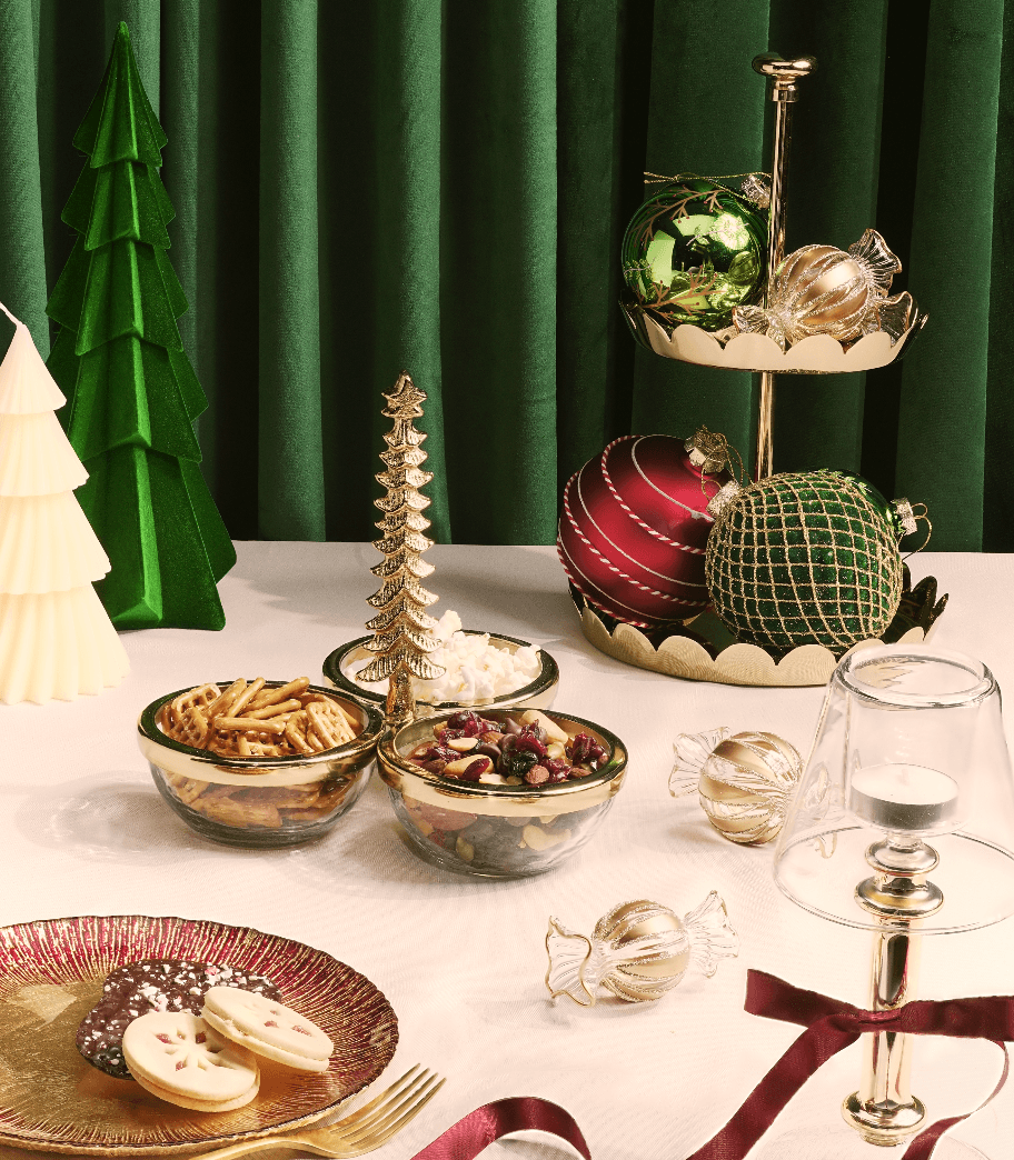 Elegant Holiday Entertaining setup with dessert stands, bowls, and festive decor for gatherings.