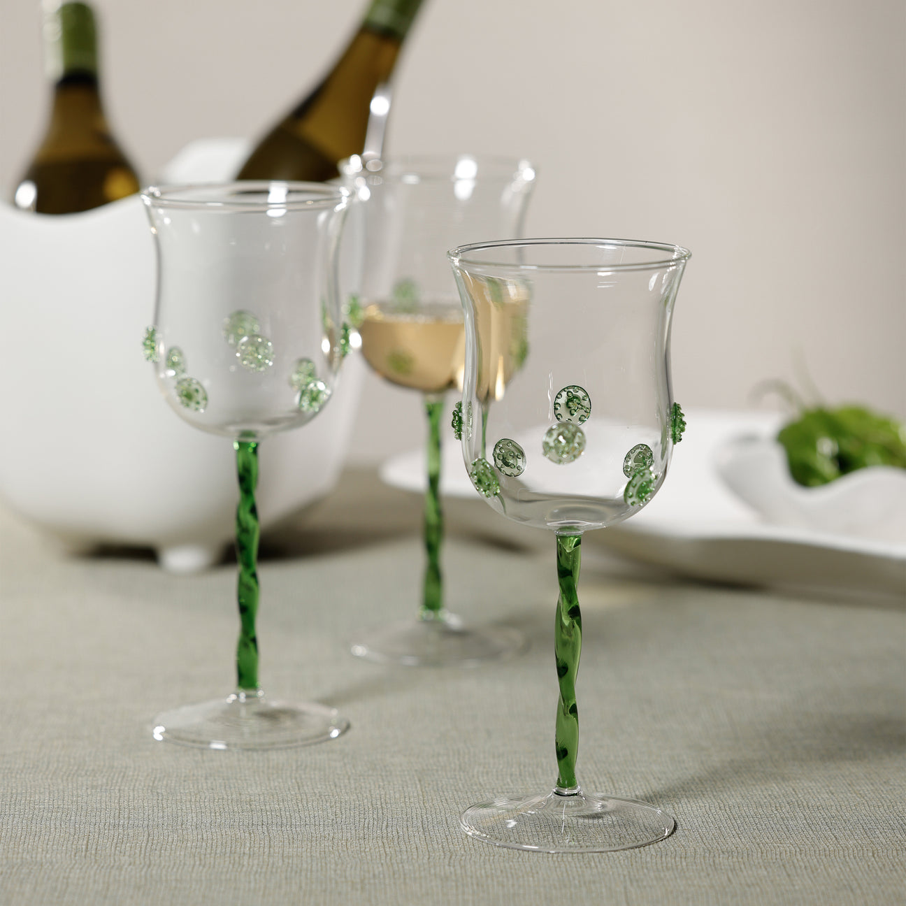 Elegant Wine Glasses with green accents, perfect for serving white wine in style.