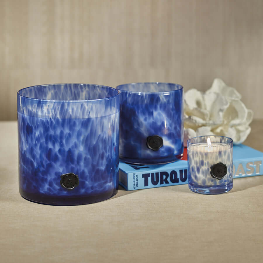 Elegant coastal home decor featuring blue candles from the Coastal Fragrances collection.