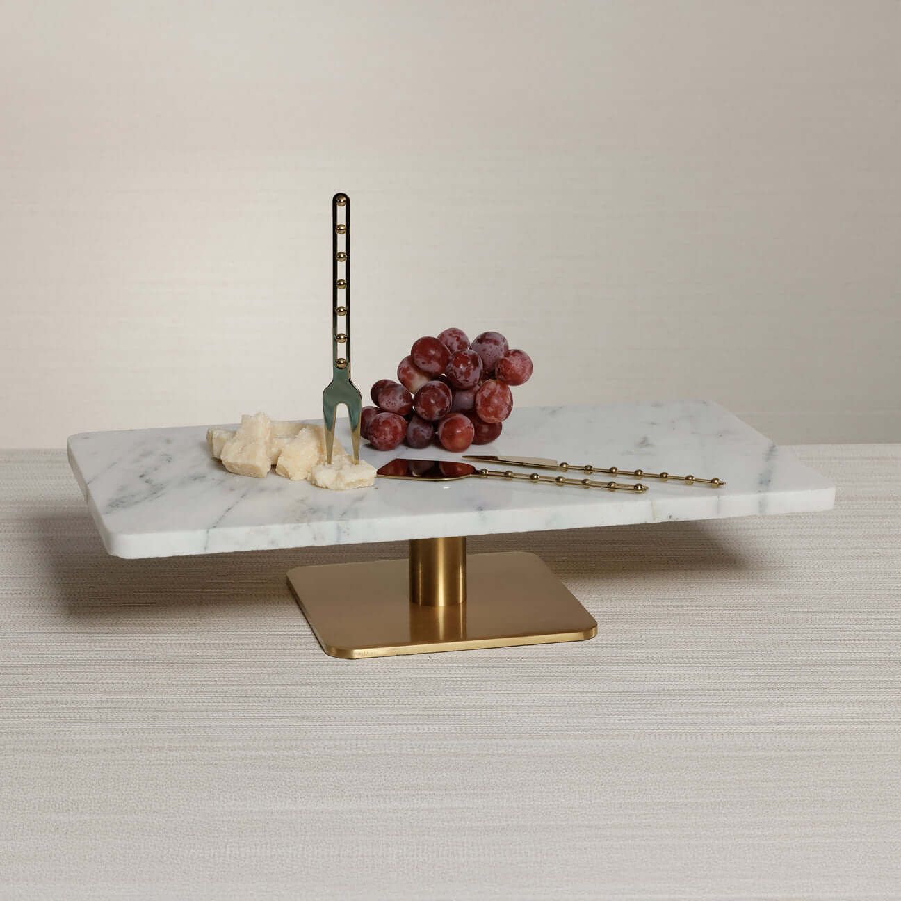 Cheese Boards and Tools featuring a marble serving tray with cheese and grapes, complemented by elegant cheese tools.