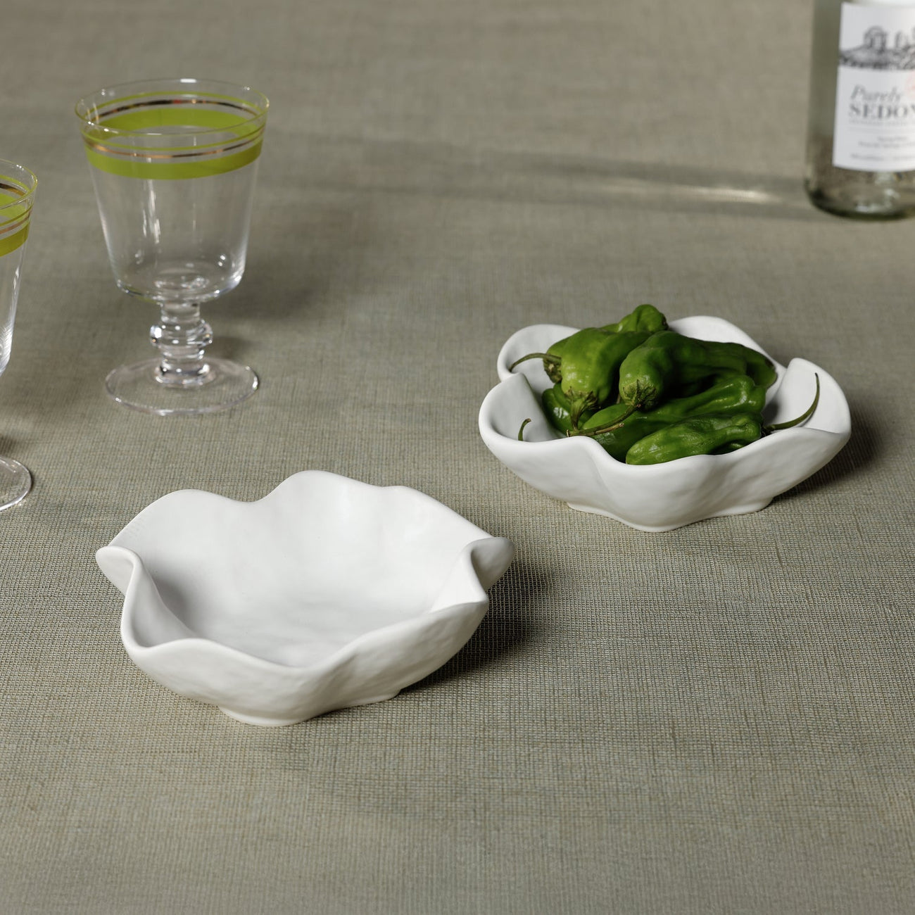 Elegant white bowls showcasing vibrant green peppers, perfect for serving snacks. Bowls enhance dining aesthetics.