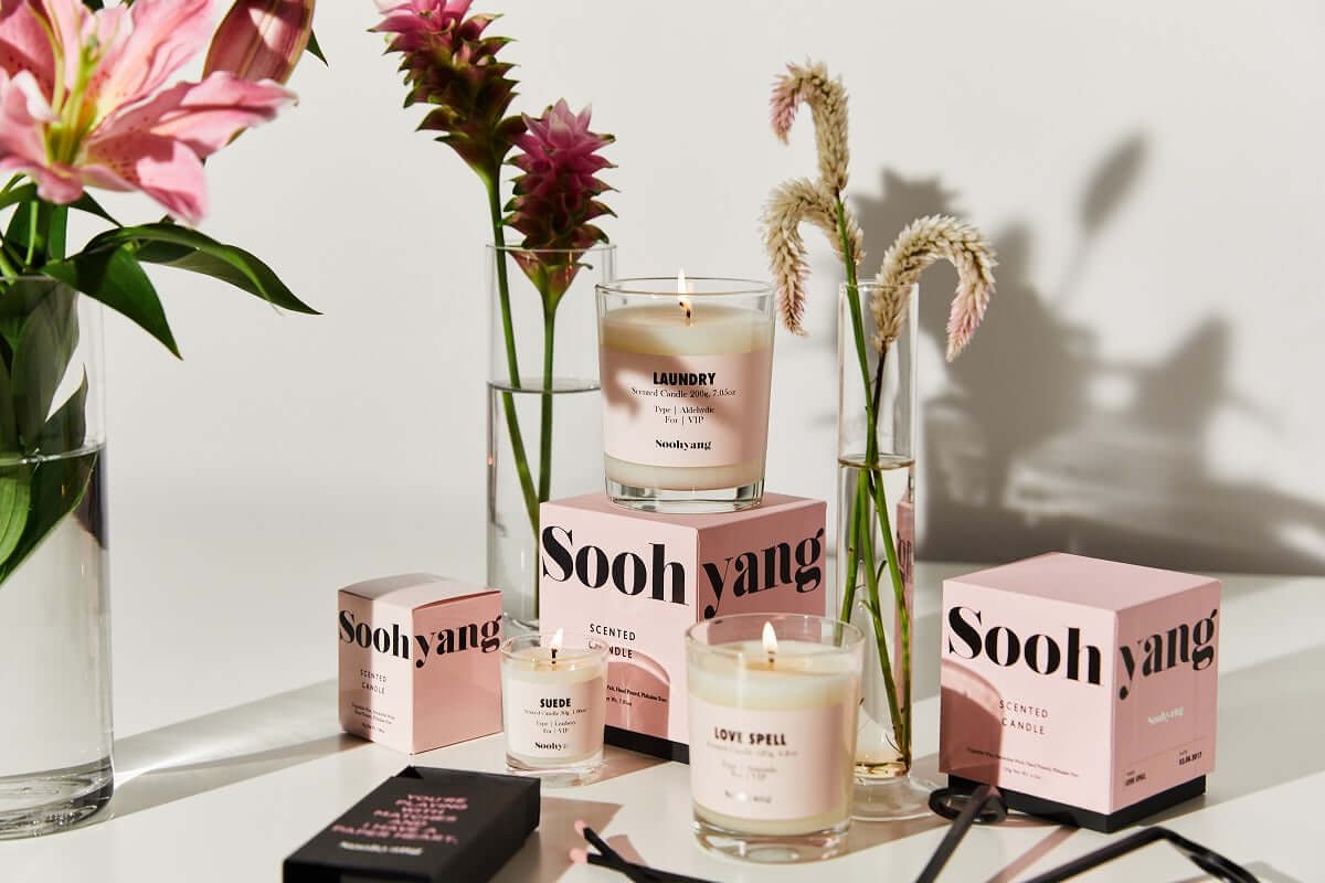 Soohyang Candles displayed with flowers and decorative elements in a stylish setup.