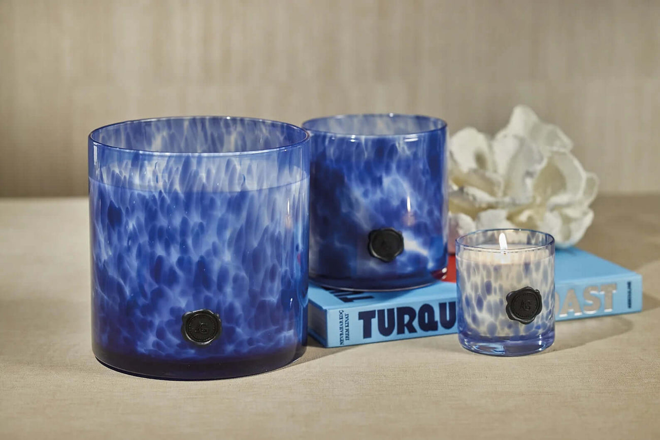 Elegant blue candle collection showcasing unique glass designs, part of our All Products home decor.