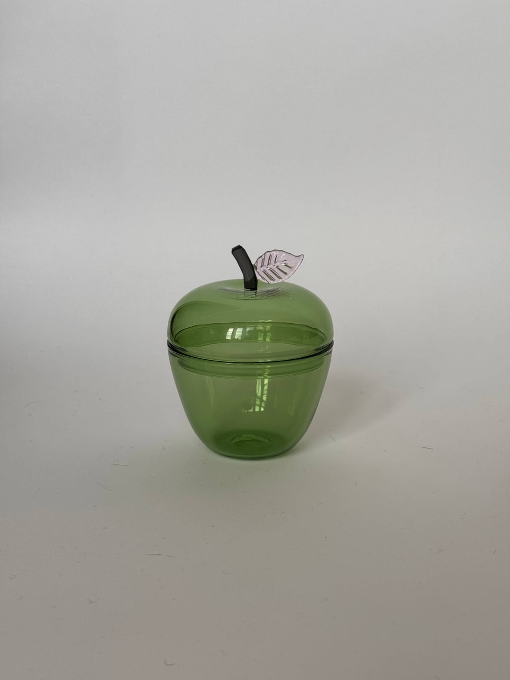 La Pomme, Green glass apple container with a removable lid and a metallic leaf detail.