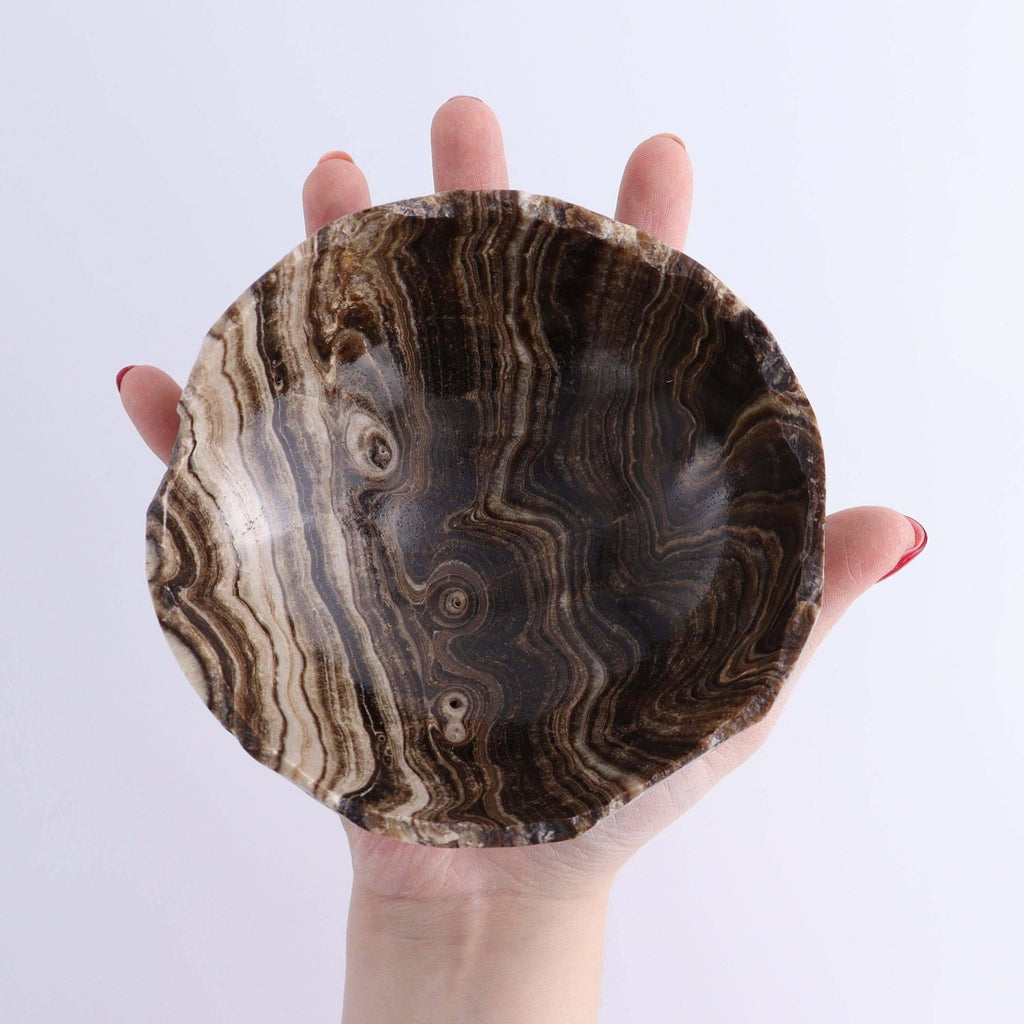 Mexican Onyx/Calcite Bowl OOAK held in hand showcasing its unique patterns and natural beauty.