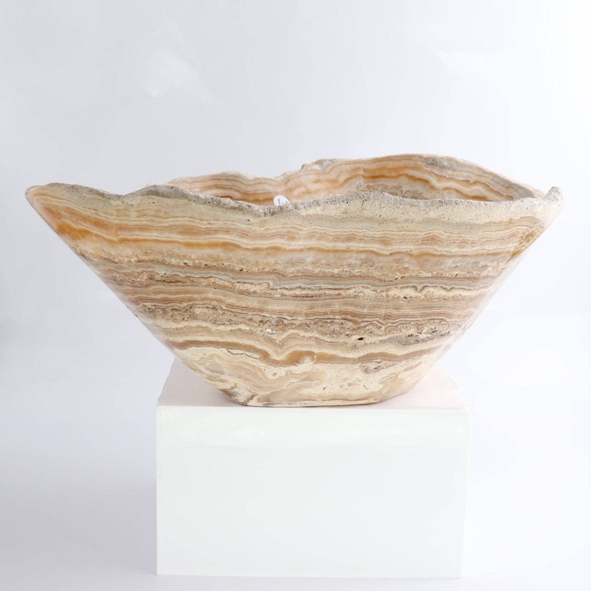 Mexican Onyx/Calcite Bowl 16" displayed on a stand, showcasing its unique amber and honey-toned banding.
