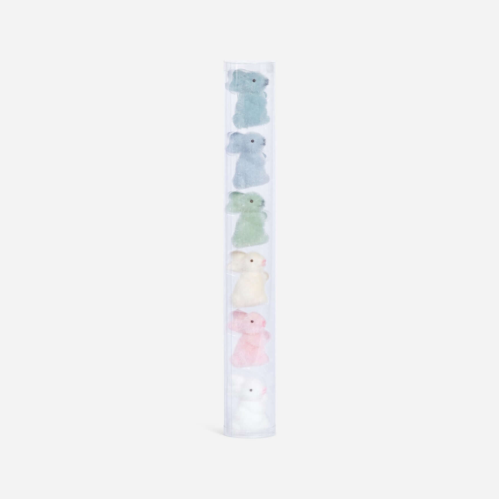 Set of pastel-colored plush toys in a clear holder on a white background