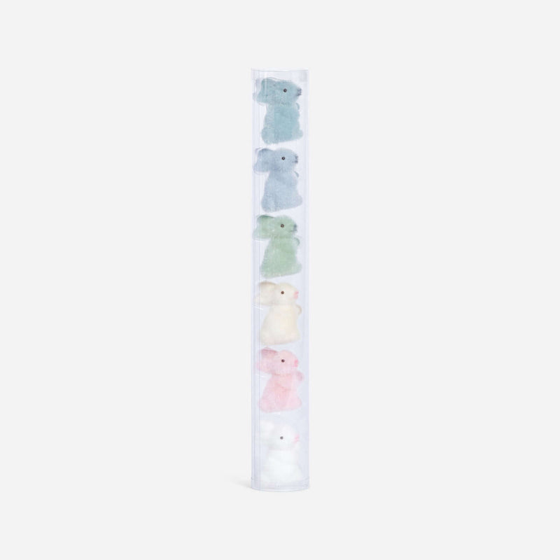 Set of pastel-colored plush toys in a clear holder on a white background