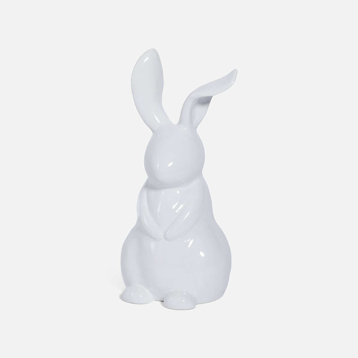 White ceramic rabbit figurine on a light gray background