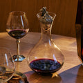 acorn decanter with red wine in it