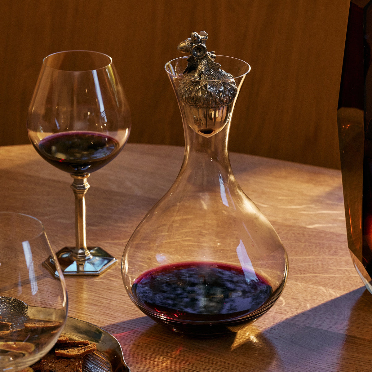 acorn decanter with red wine in it