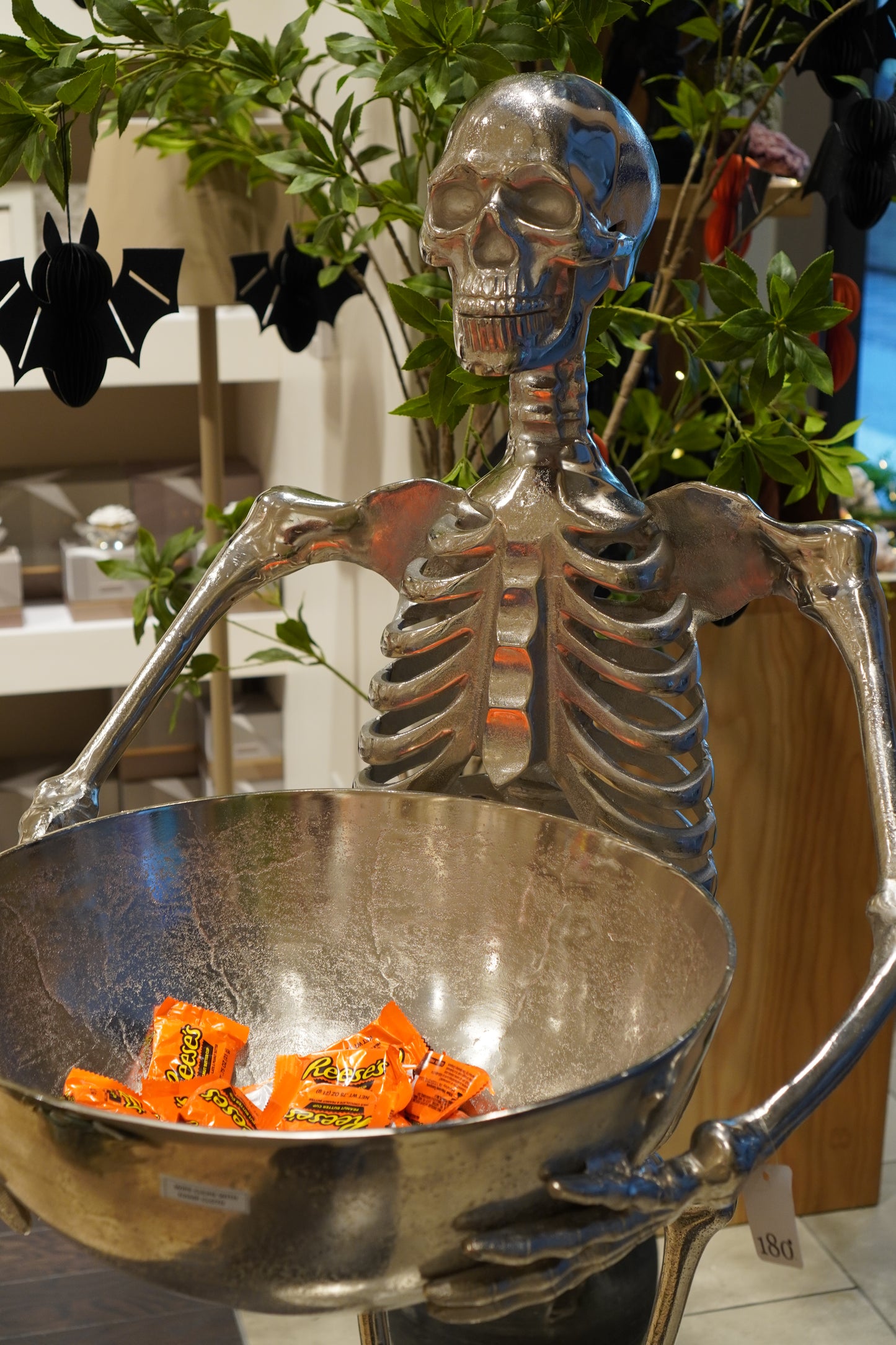 silver skeleton holding candy bowl