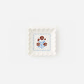 Jardin Floral Porcelain Plate - Set of 2, scalloped-edge plate with red carnations and blue stems.