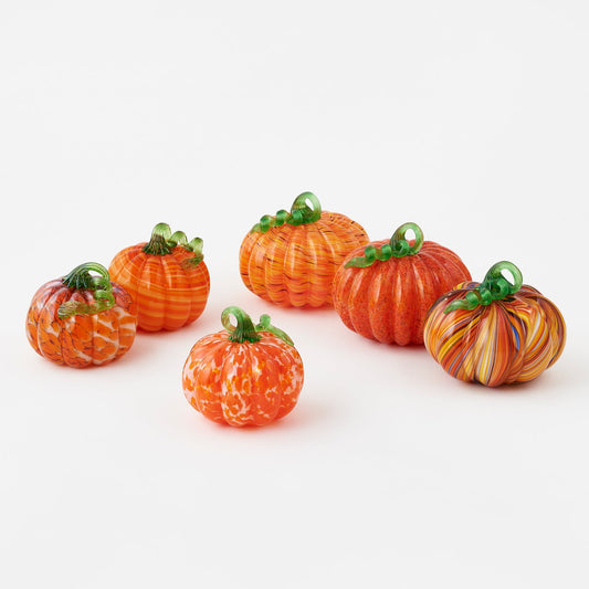 Colorful glass pumpkins on a white background