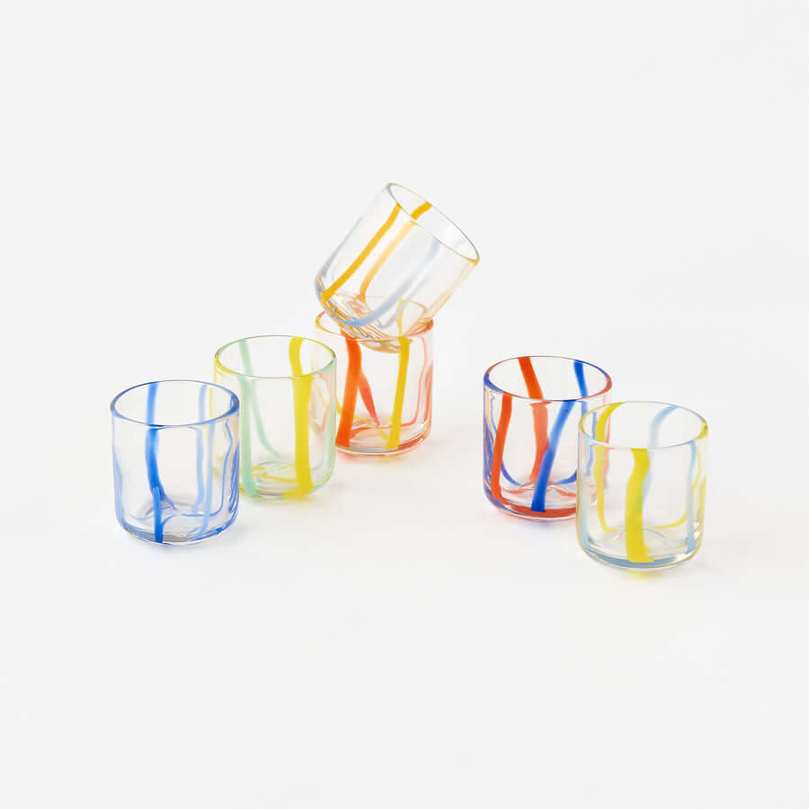 Terrazzo Striped Drinking Glass - Set of 6 Assorted showcasing colorful striped tumblers stacked together.