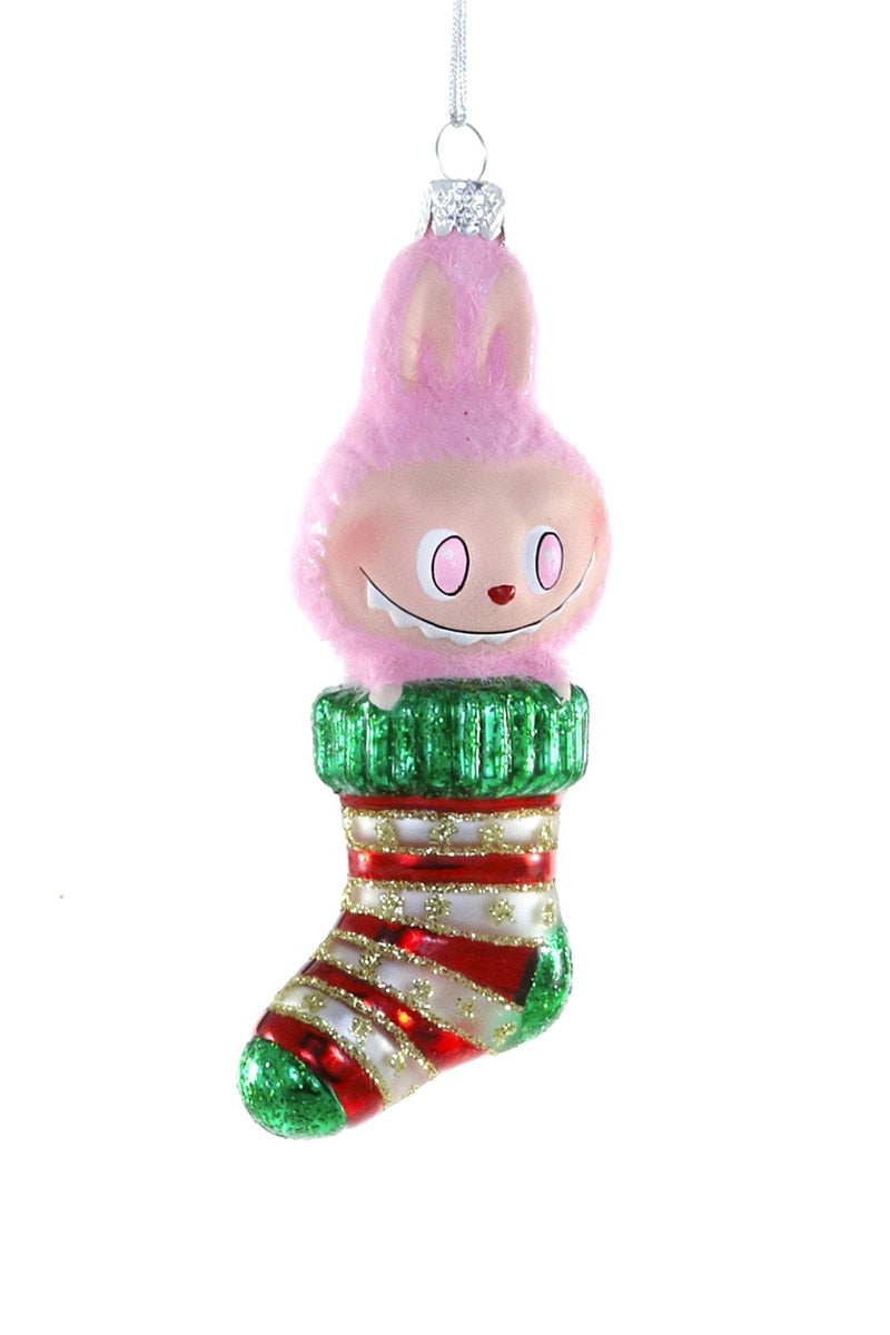 Decorative Christmas ornament of a character with pink hair and a striped stocking on a white background