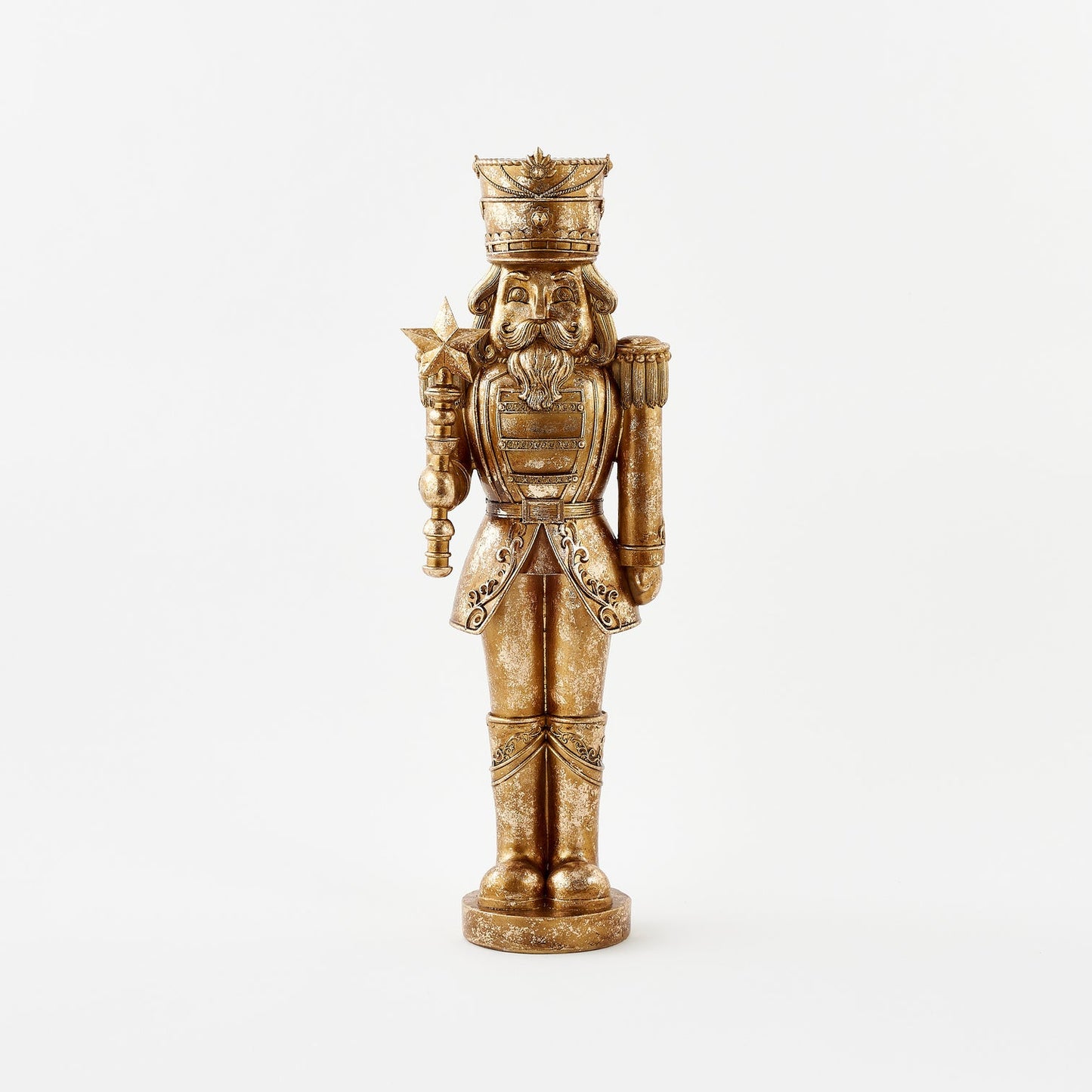 Decorative nutcracker figurine with intricate details on a white background