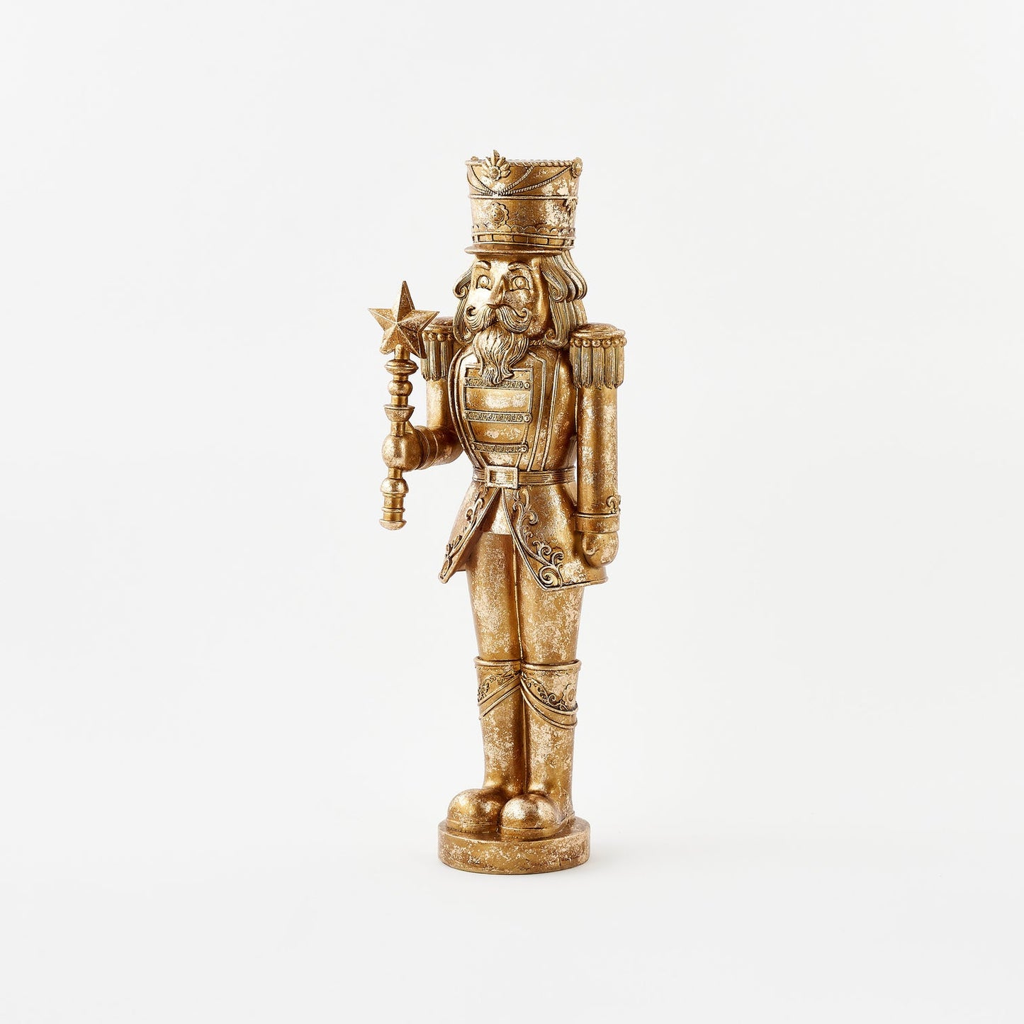 Gold figurine of a bearded warrior with a crown and armor on a white background