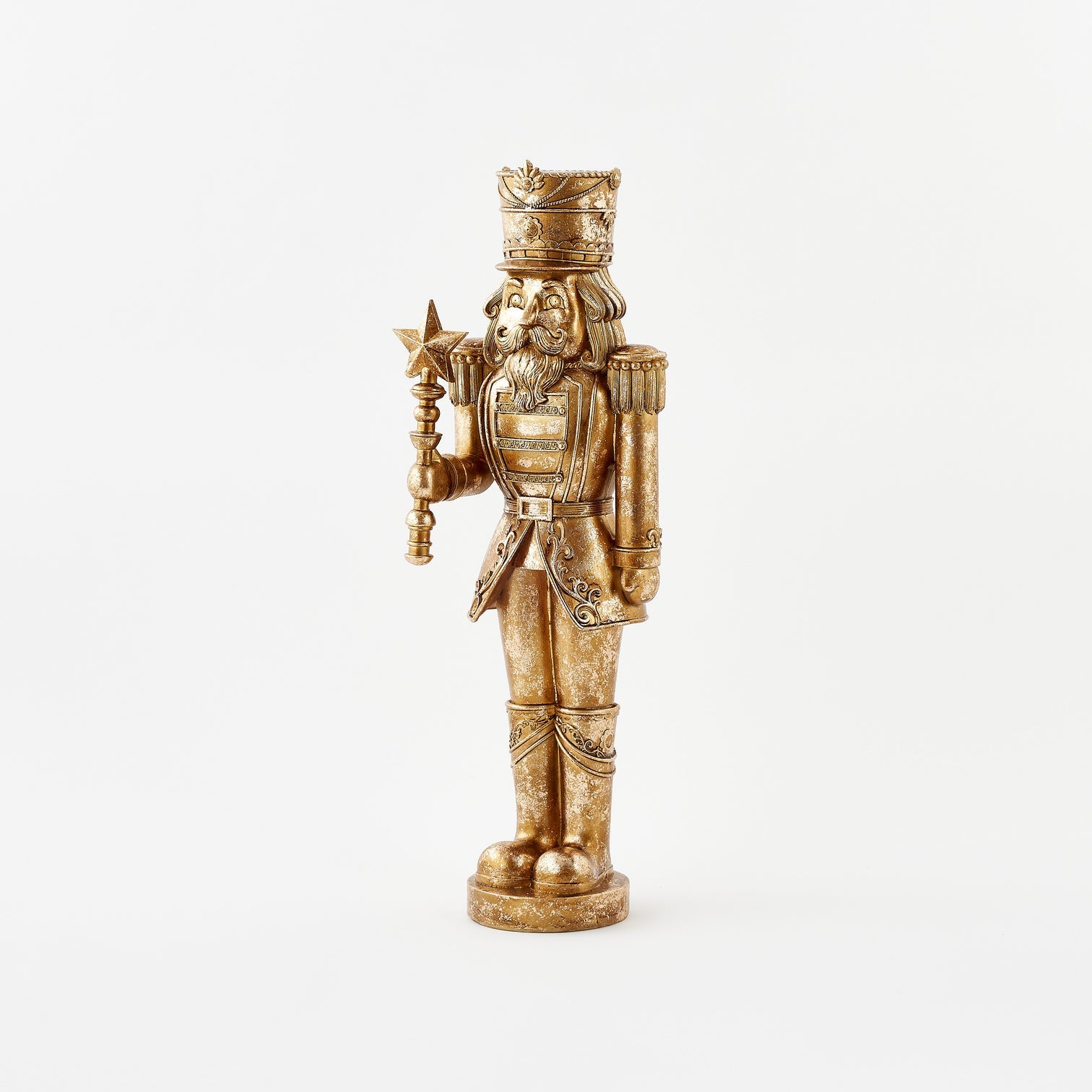 Gold figurine of a bearded warrior with a crown and armor on a white background