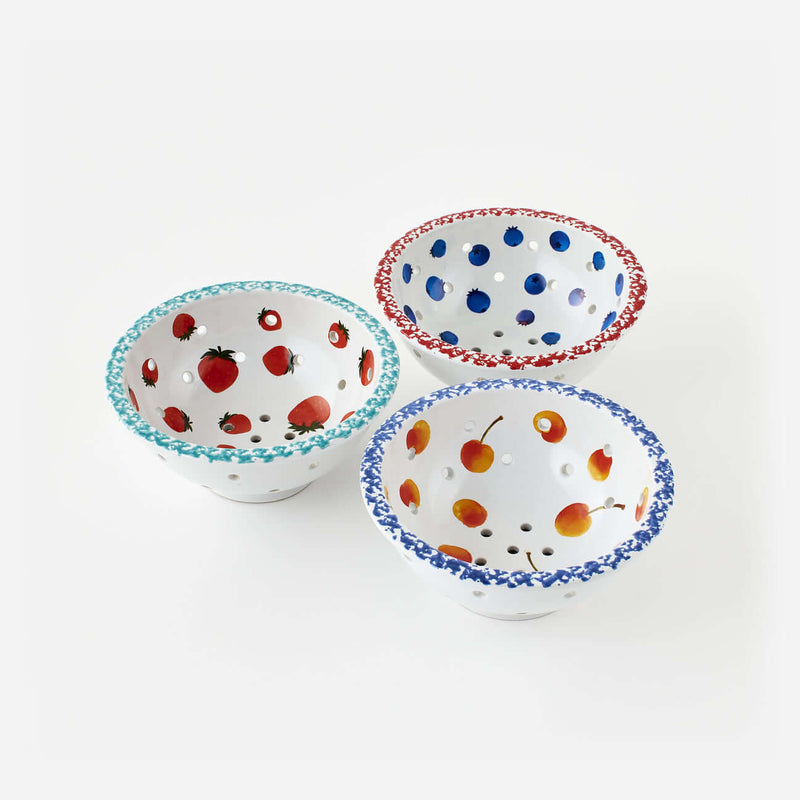 Set of 3 Assorted Berry Bowls with hand-painted fruit designs in various colors and perforated for draining.