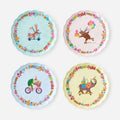 Set of four party plates with colorful animal birthday illustrations.