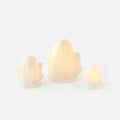 Three lightbulb-shaped candles on a white background