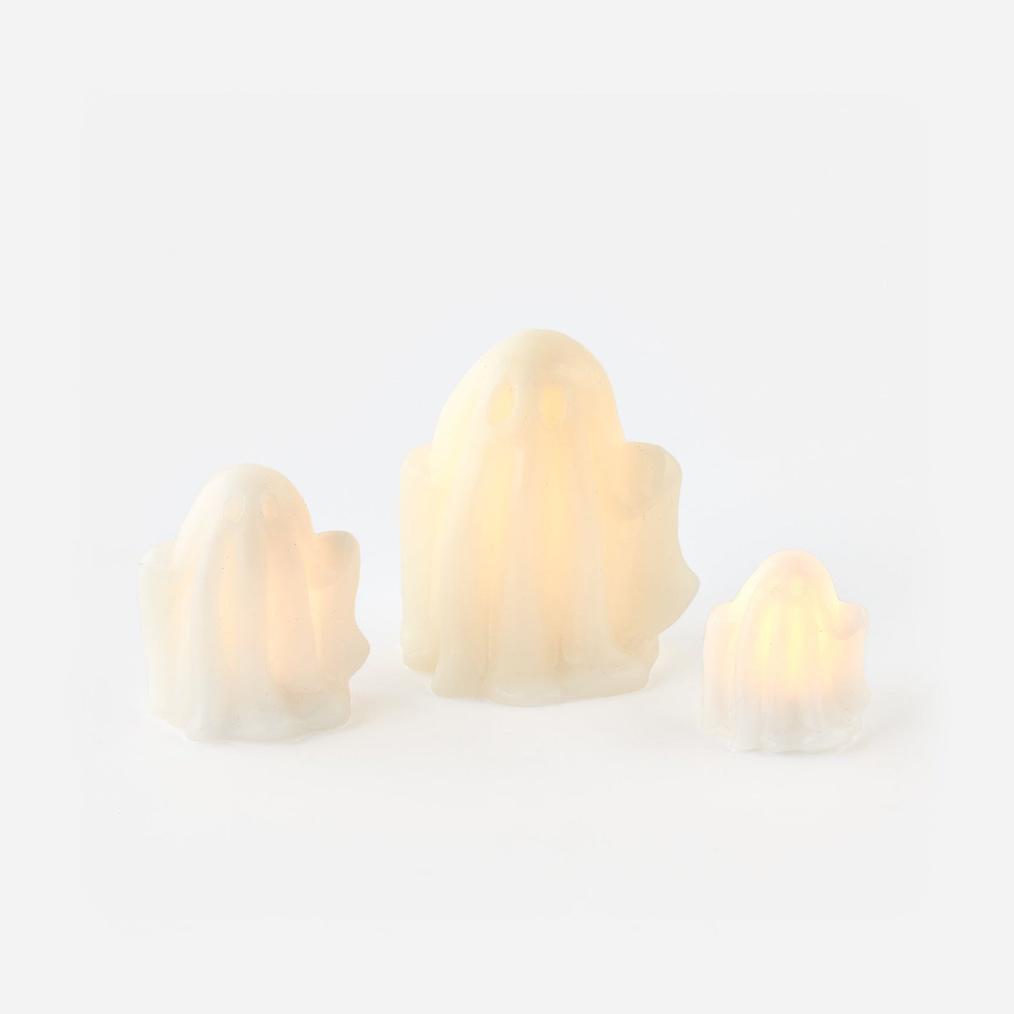 Three lightbulb-shaped candles on a white background