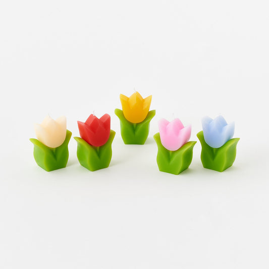 Set of colorful tulip-shaped candles on a white background