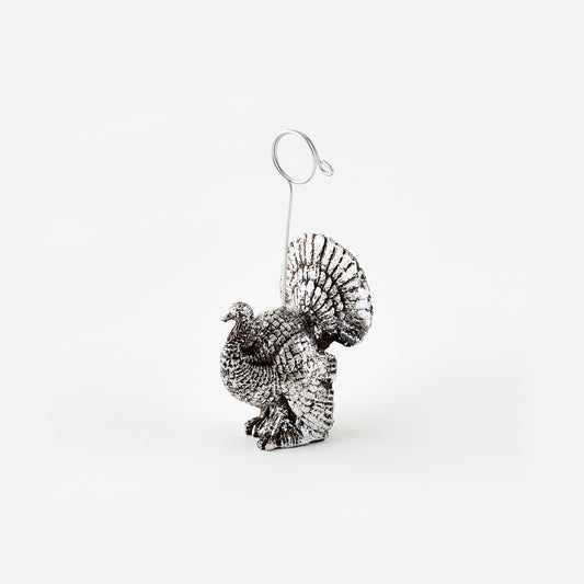 Metallic turkey place card holder on a white background
