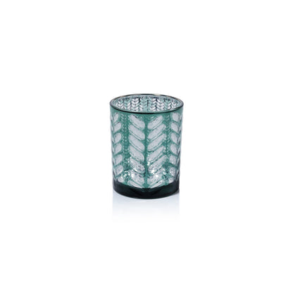 Decorative glass candle holder with leaf pattern on a white background