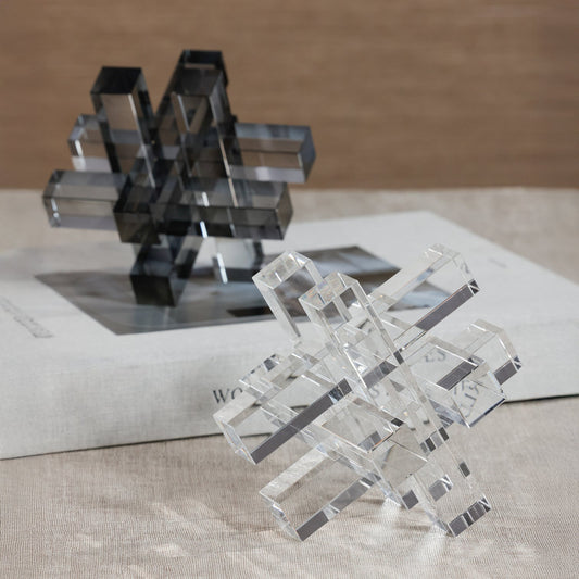 Crystal geometric sculptures on a textured surface with a blurred background