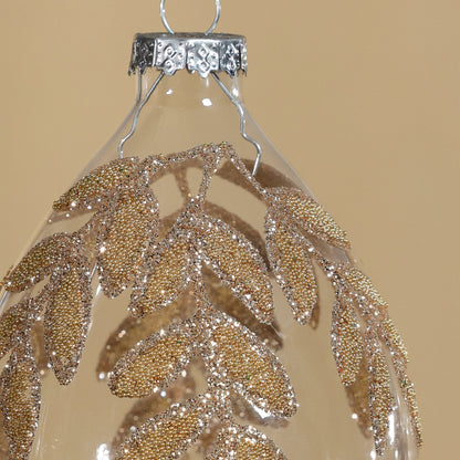 Decorative hanging ornament with gold leaf pattern on a beige background