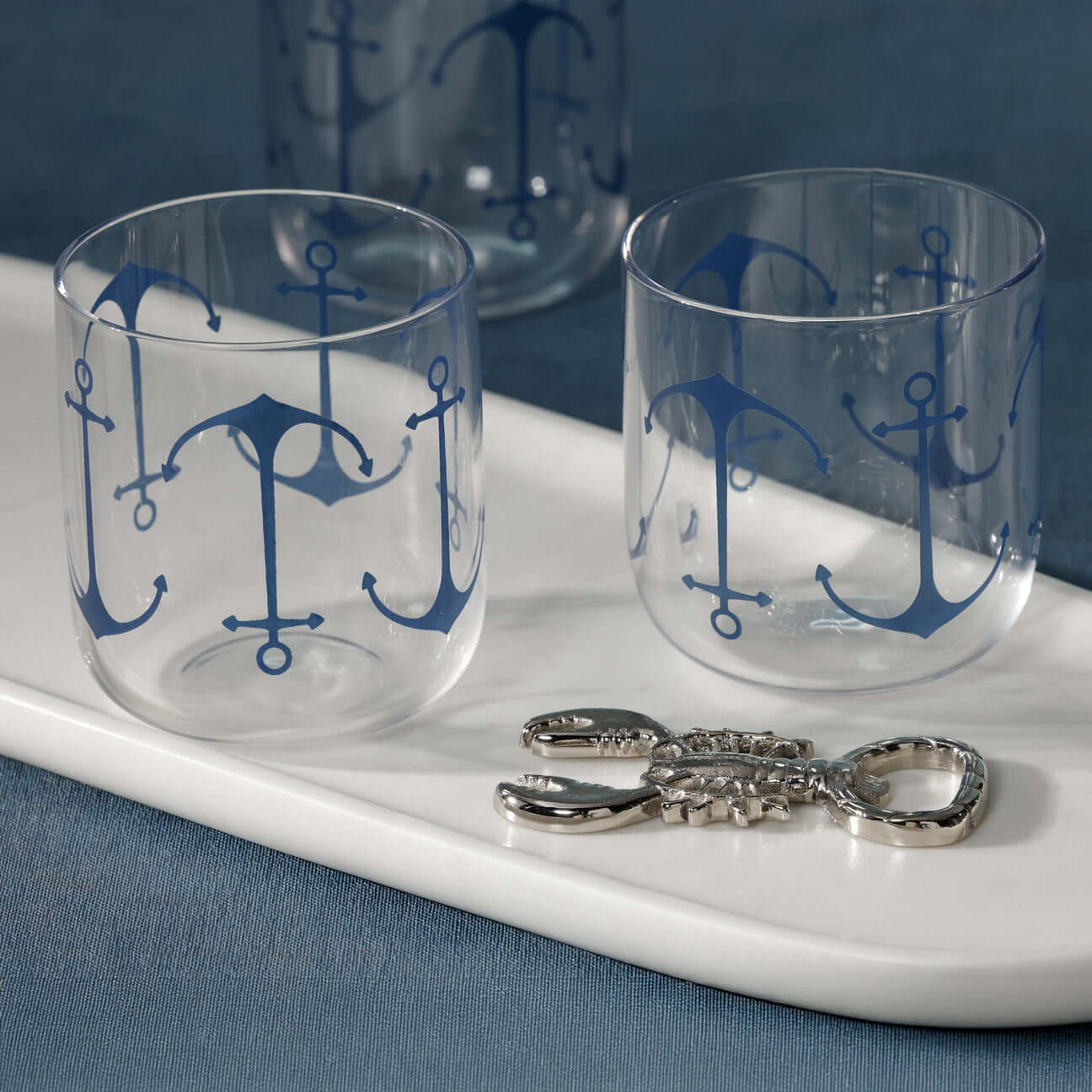 Anchor Design Rocks Glass - Boat Edition (Set of 6) with blue anchor motifs on a white tray.