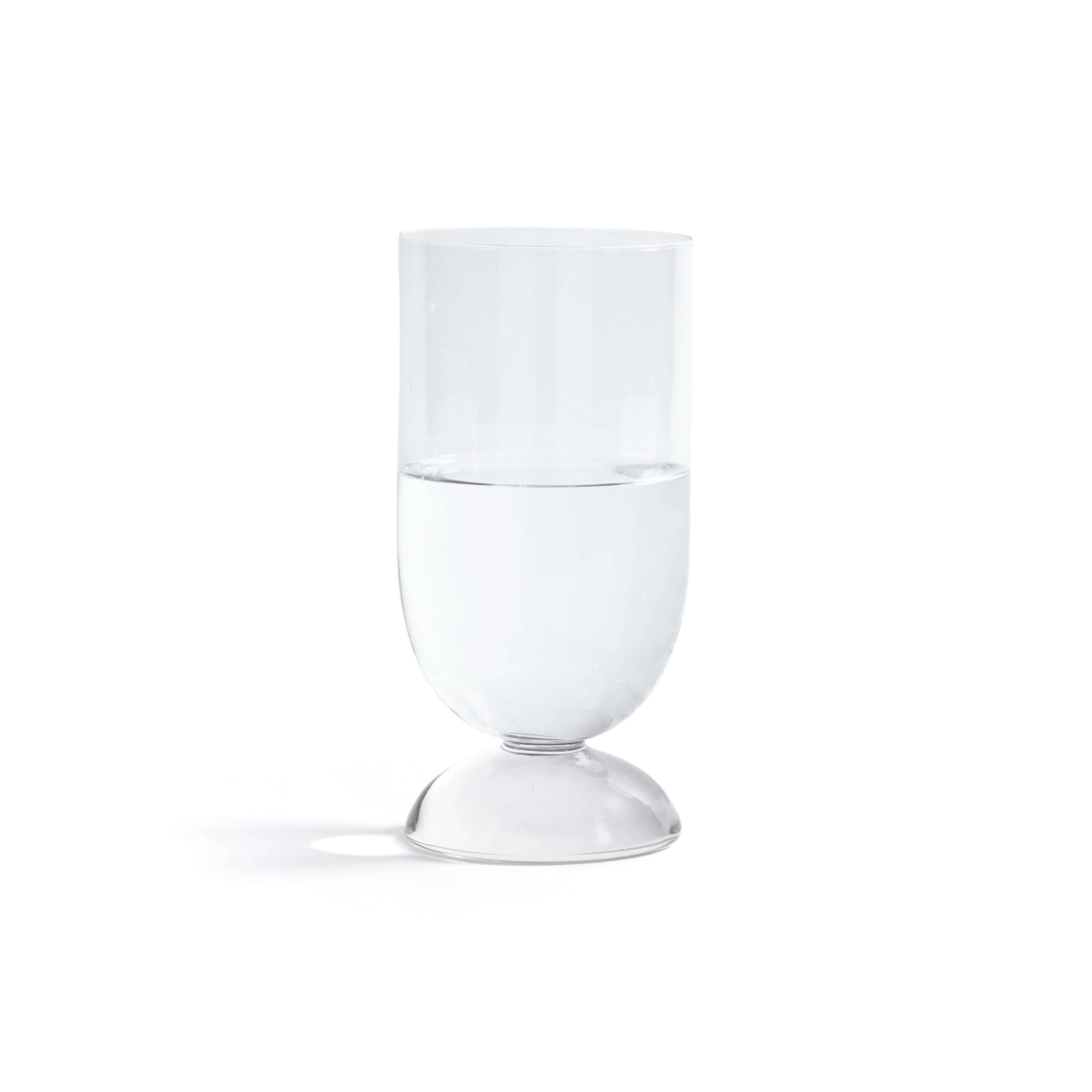 Madrid Glassware Collection clear glass with solid sphere base holding water on white background.