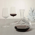 Octopus Wine Decanter with two glasses of red wine on a table, combining elegance and coastal charm.