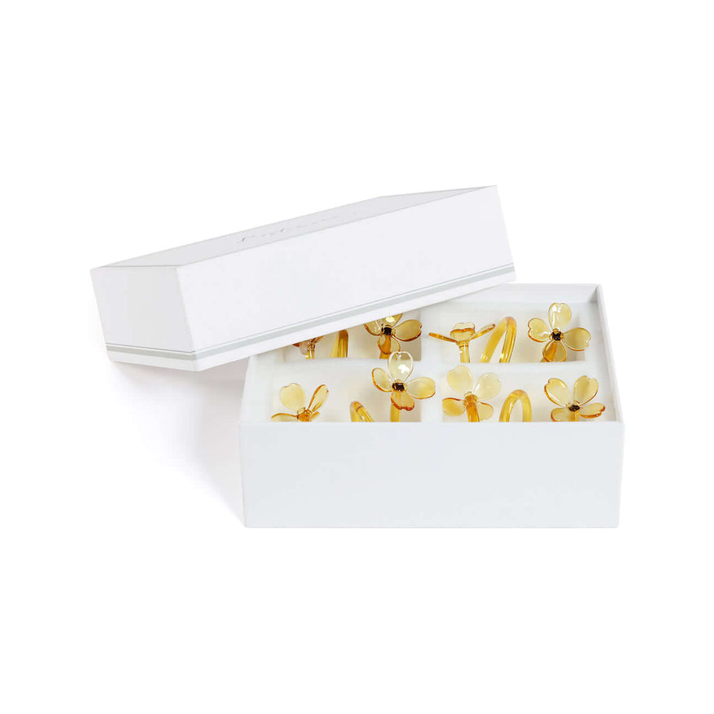 Four Botanica Glass Flower Napkin Rings - Boxed (Set of 4) in elegant packaging featuring delicate glass flower designs.