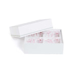 Four Botanica Glass Flower Napkin Rings - Boxed (Set of 4) in a white gift box, showcasing delicate pink glass flower designs.