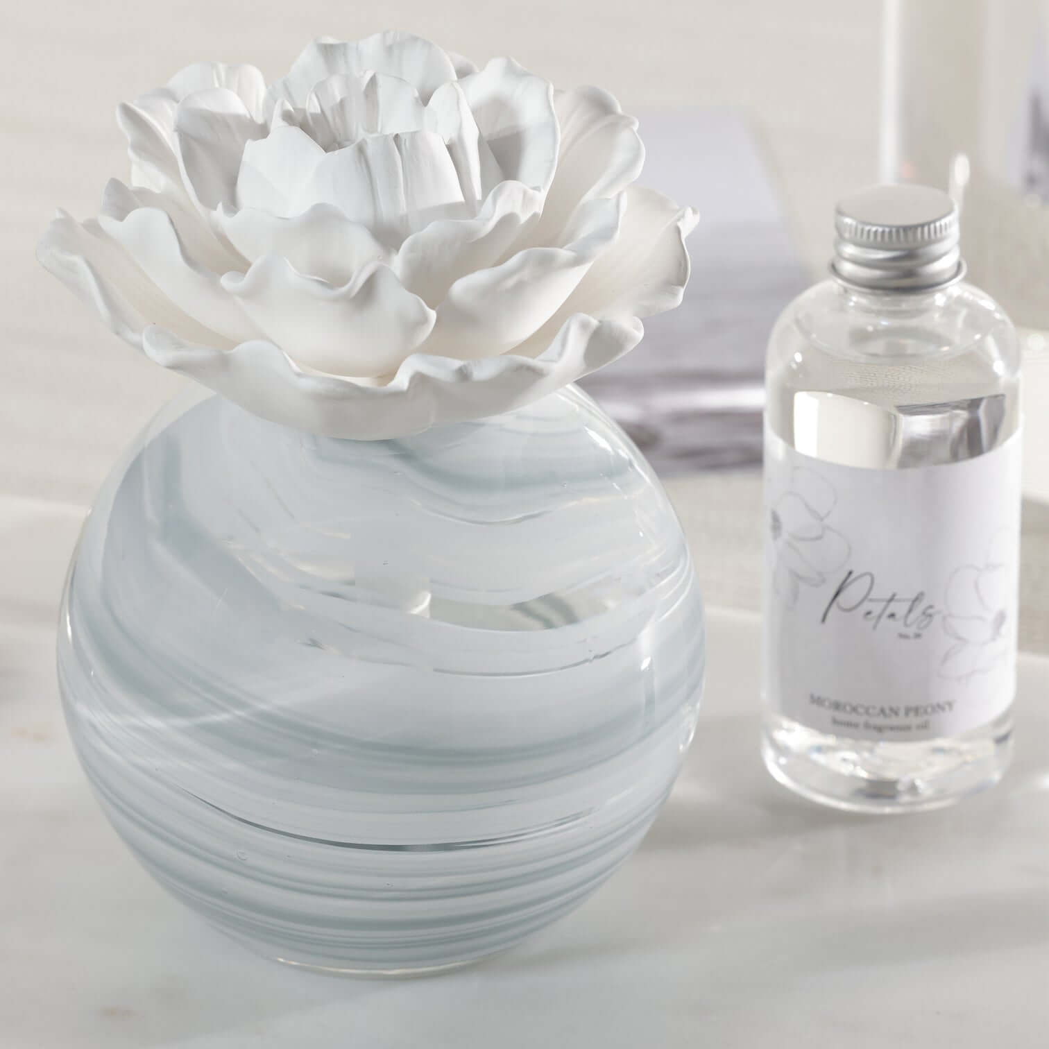Petals Porcelain Diffuser - Large with marbled glass vessel and delicate porcelain flower.