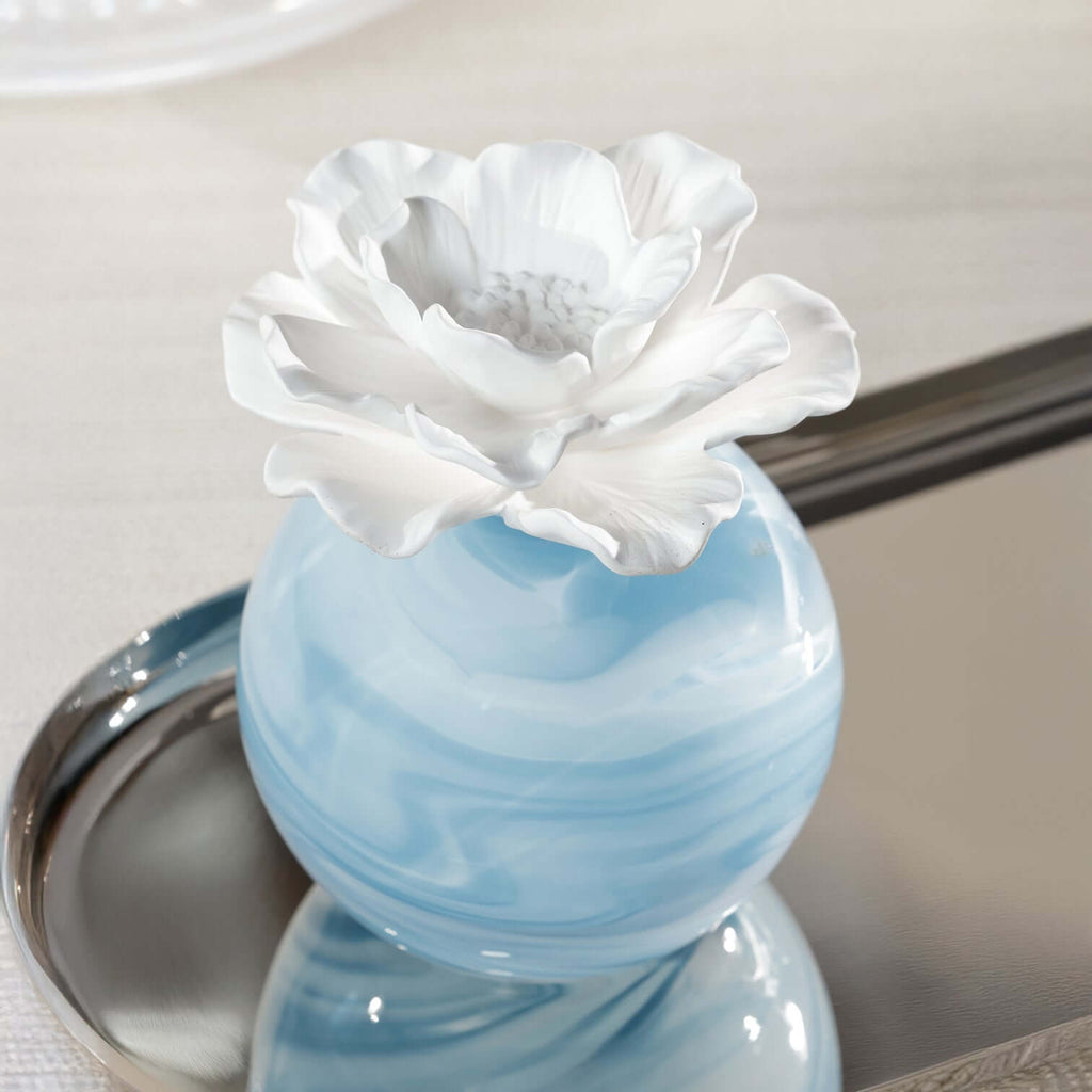 Petals Porcelain Diffuser - Large with blue marbled glass and white porcelain flower on a silver tray