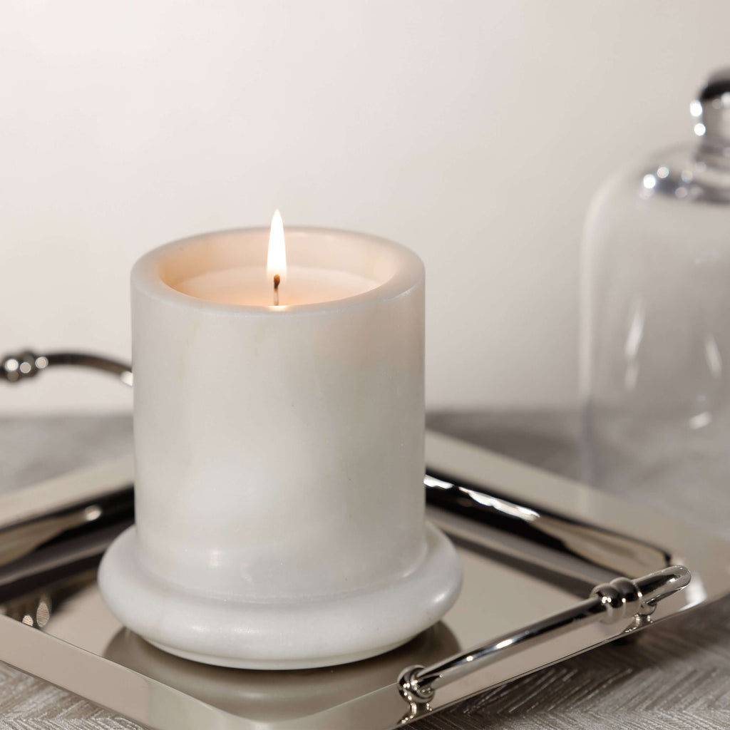 Marbella Scented Candle Jar with Cloche on a silver tray, featuring a flickering flame and elegant design.