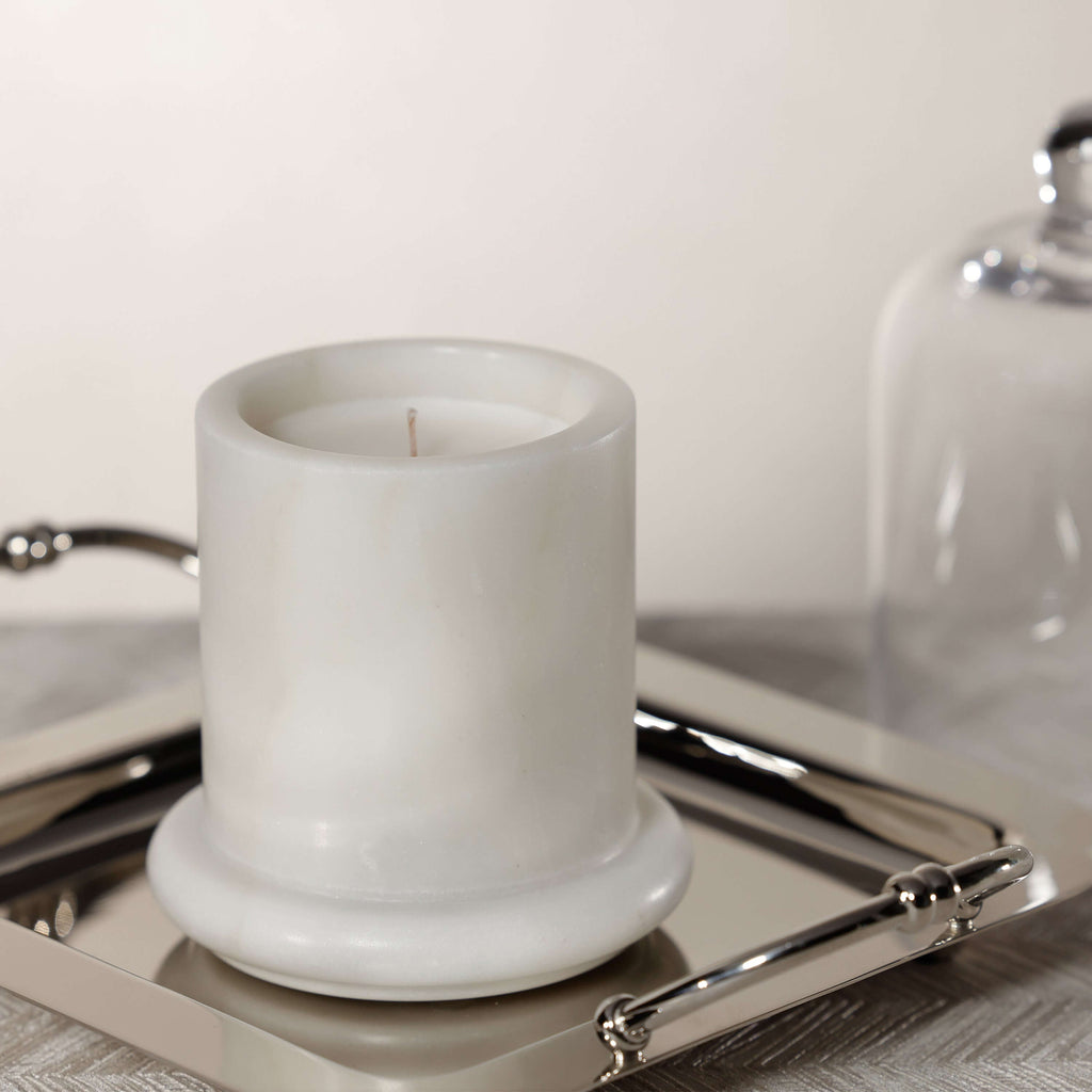 Marbella Scented Candle Jar with Cloche on a silver tray, showcasing unique marble design.