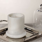 Marbella Scented Candle Jar with Cloche on a silver tray, showcasing unique marble design.