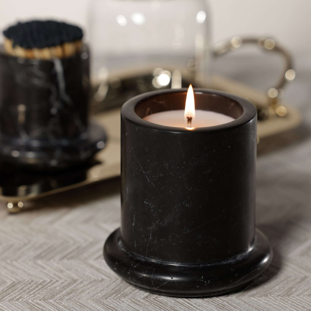 Marbella Scented Candle Jar with Cloche burning in a black marble jar with a soft glow.