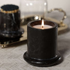 Marbella Scented Candle Jar with Cloche burning in a black marble jar with a soft glow.
